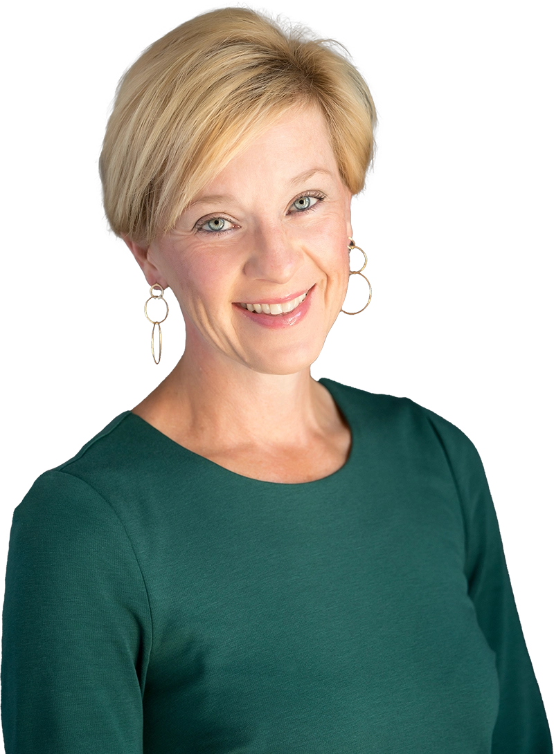Professional headshot of Gaston Group leadership wearing a green dress and gold earrings.